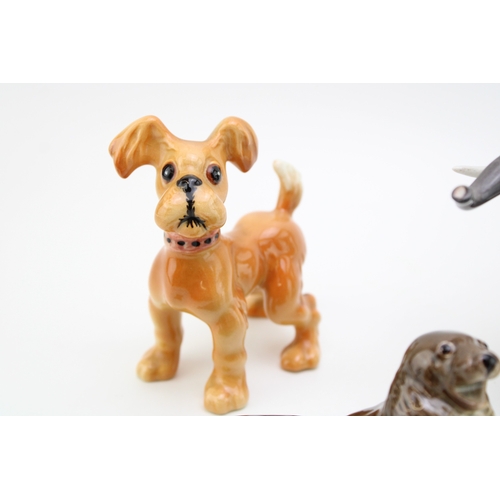 48 - Beswick to include an elephant, a terrier, a seal (restored) and a comical dog (4).