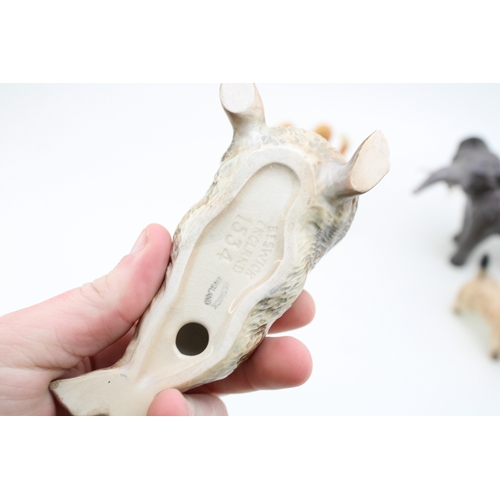 48 - Beswick to include an elephant, a terrier, a seal (restored) and a comical dog (4).
