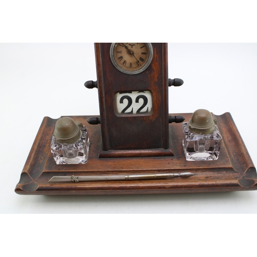 25A - An Edwardian oak perpetual calendar cum desk tidy, with central clock to calendar and scrolling days... 