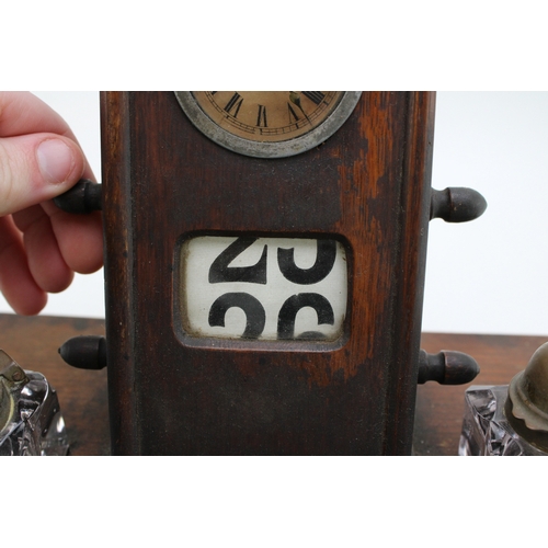 25A - An Edwardian oak perpetual calendar cum desk tidy, with central clock to calendar and scrolling days... 