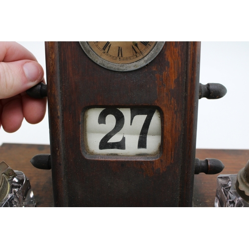25A - An Edwardian oak perpetual calendar cum desk tidy, with central clock to calendar and scrolling days... 