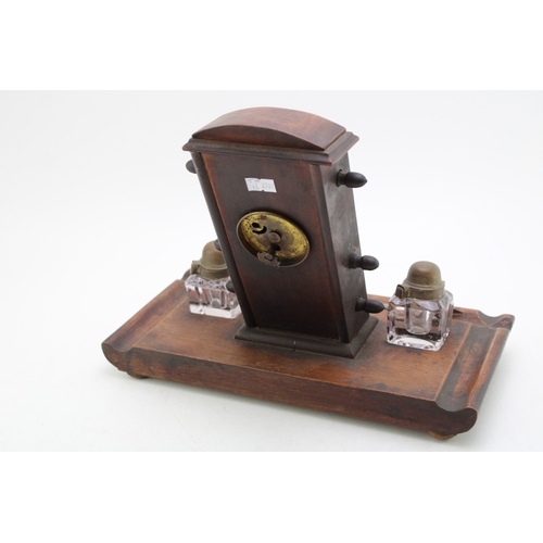 25A - An Edwardian oak perpetual calendar cum desk tidy, with central clock to calendar and scrolling days... 