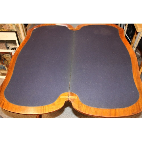15A - A Victorian burr walnut stretcher card table, featuring serpentine-shaped top with walnut veneer and... 
