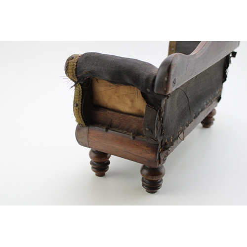 16 - A Regency miniature mahogany framed sofa with serpentine back and upholstered panel, raised on four ... 