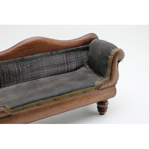 16 - A Regency miniature mahogany framed sofa with serpentine back and upholstered panel, raised on four ... 