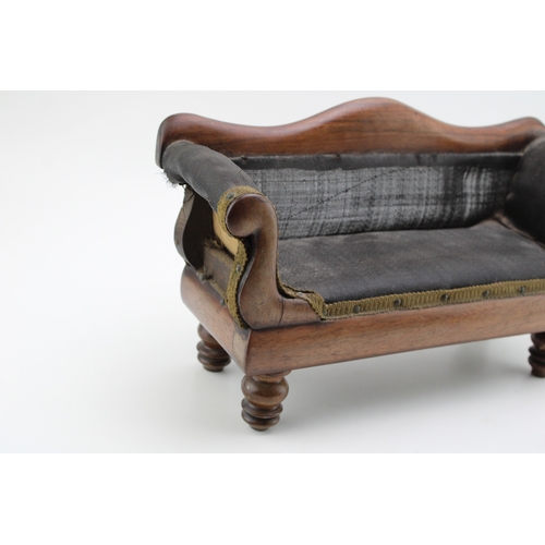 16 - A Regency miniature mahogany framed sofa with serpentine back and upholstered panel, raised on four ... 