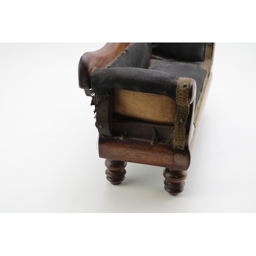16 - A Regency miniature mahogany framed sofa with serpentine back and upholstered panel, raised on four ... 