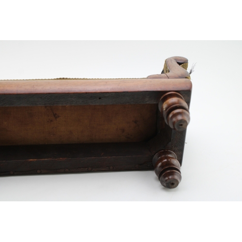 16 - A Regency miniature mahogany framed sofa with serpentine back and upholstered panel, raised on four ... 