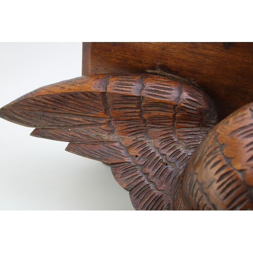 17 - A Victorian carved wall shelf in the form of an eagle facing left, black forest style, 50cm wide, wi... 