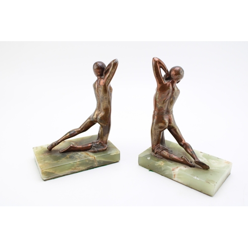 25 - A pair of antique mounted bronze figures of a person holding a robe, a true pair, 18cm tall, mounted... 