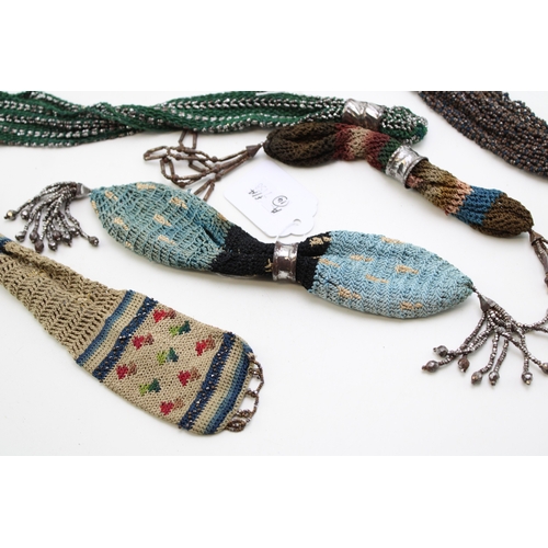 34 - Eight 19th century ‘miser’s purses’, comprising cotton examples in a variety of colours with cut and... 