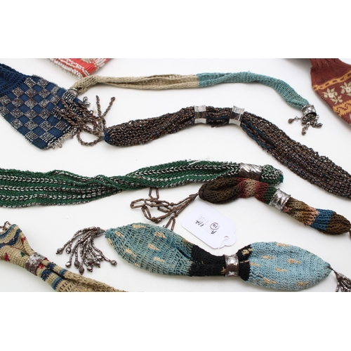 34 - Eight 19th century ‘miser’s purses’, comprising cotton examples in a variety of colours with cut and... 