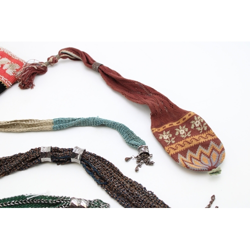 34 - Eight 19th century ‘miser’s purses’, comprising cotton examples in a variety of colours with cut and... 