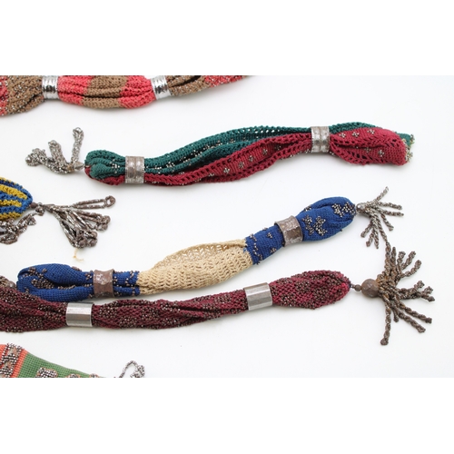 35 - Ten 19th century ‘miser’s purses’, comprising cotton examples in a variety of colours with cut and p... 