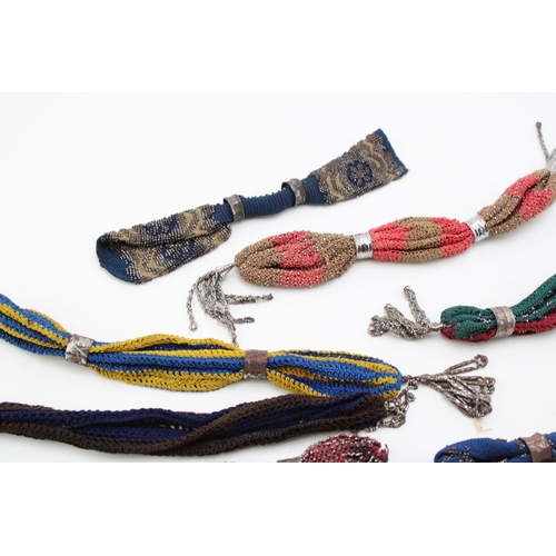 35 - Ten 19th century ‘miser’s purses’, comprising cotton examples in a variety of colours with cut and p... 