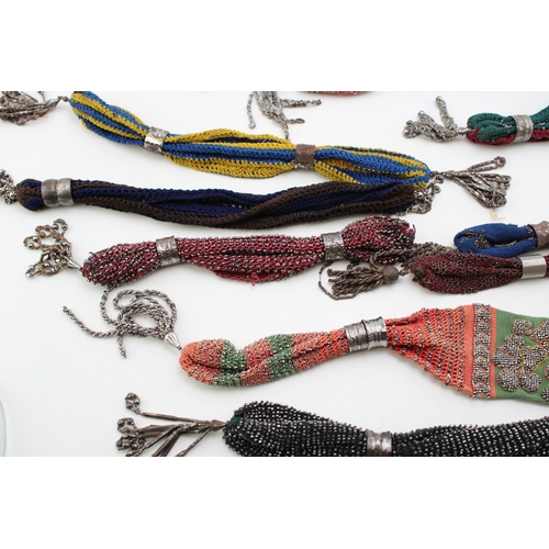 35 - Ten 19th century ‘miser’s purses’, comprising cotton examples in a variety of colours with cut and p... 