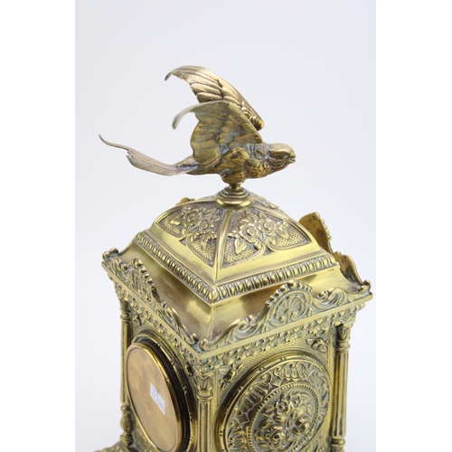53 - A late 19th century French brass mantel clock, with roman numerals to the brass dial, with bird in f... 