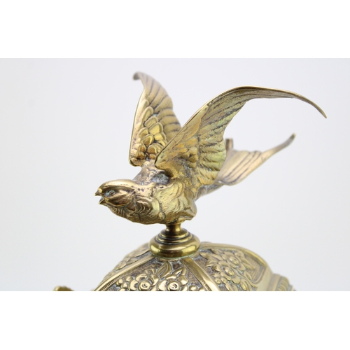 53 - A late 19th century French brass mantel clock, with roman numerals to the brass dial, with bird in f... 