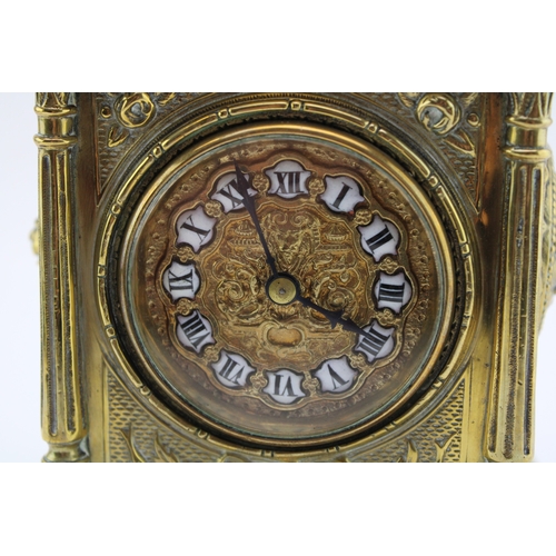 53 - A late 19th century French brass mantel clock, with roman numerals to the brass dial, with bird in f... 