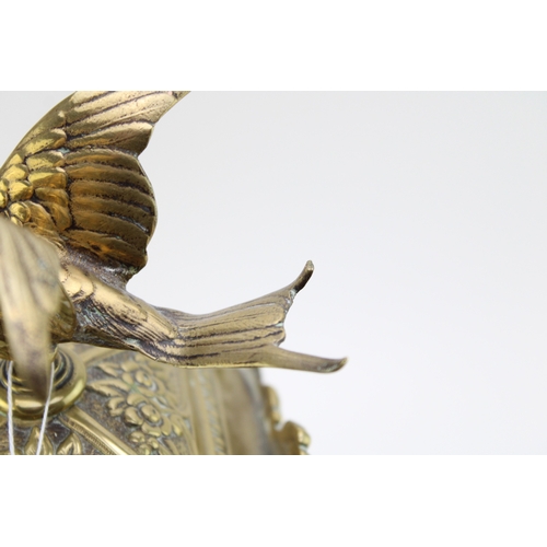 53 - A late 19th century French brass mantel clock, with roman numerals to the brass dial, with bird in f... 