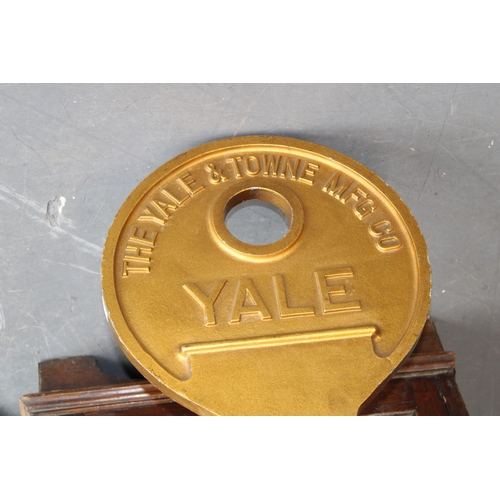 3 - An oversized Yale metal advertising sign in the form of a key, 78cm long.