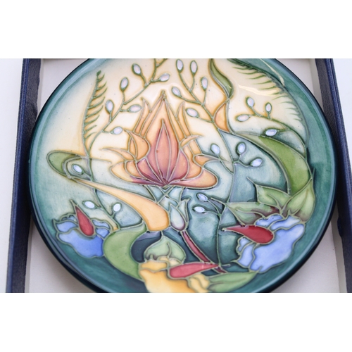 302 - Boxed Moorcroft pin dish with floral pattern, 12cm diameter.