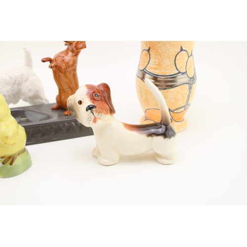 329 - Beswick to include a dachshund ashtray and a comical dog with a Doulton Terrier HN1031, a Wade chick... 