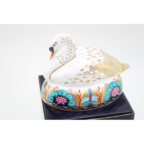 348 - Royal Crown Derby Paperweight, White Swan nesting, date mark for 1996 (LIX), gold stopper and red Ro... 