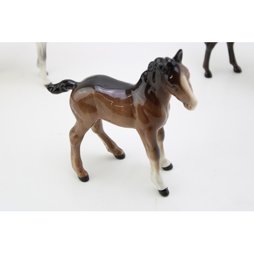 10 - Two Beswick Arab Xayal horses in brown and grey with a large brown shire foal (3).
