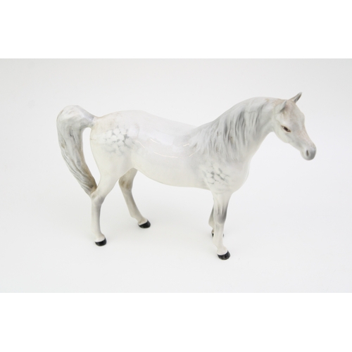 10 - Two Beswick Arab Xayal horses in brown and grey with a large brown shire foal (3).