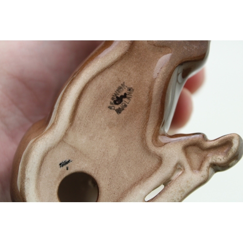 16 - Beswick to include a brown lying shire foal, a head up pony and a palomino foal (3).