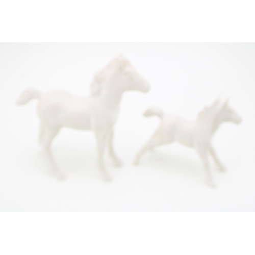19 - Beswick stretched foal, facing left, 997, in matt white with one other (2).