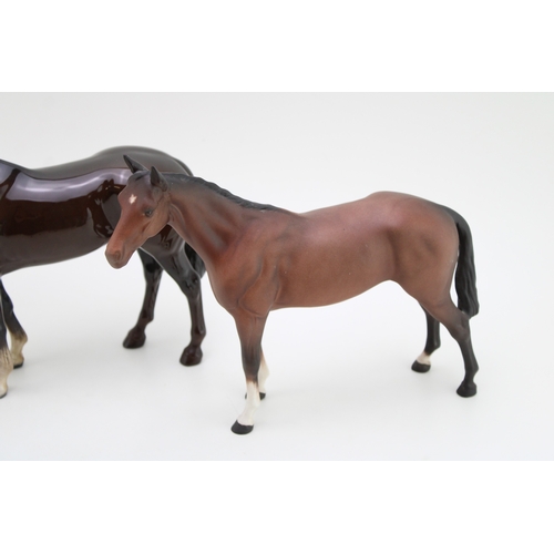 20 - Three Beswick horses to include The Winner 2421, a matt brown bois roussell and a head down leg tuck... 