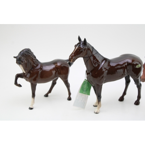 20 - Three Beswick horses to include The Winner 2421, a matt brown bois roussell and a head down leg tuck... 