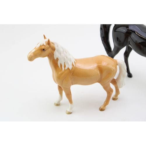 22 - Three Beswick horses to include an Arab Xayal, a brown head up pony and a palomino version (3).