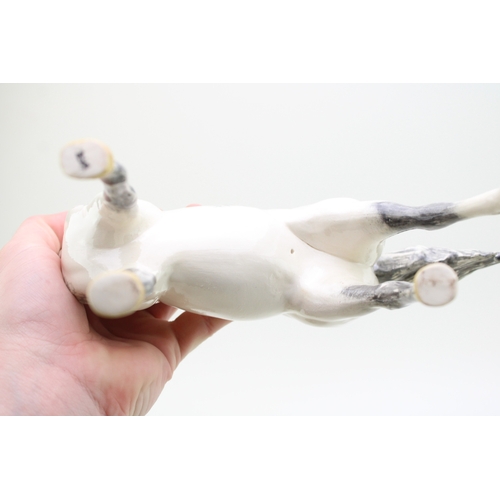 24 - Two John Beswick Horses with an unmarked pottery horse (3).