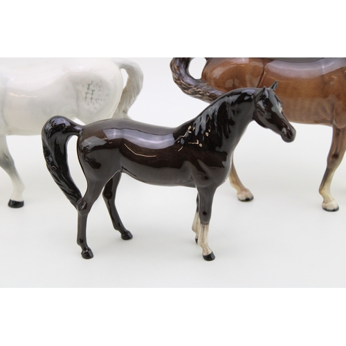 40 - Beswick horses to include a grey mare facing left and brown swishtail with an arab xayal (3).