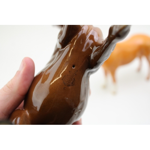 42 - Beswick horses to include a palomino imperial, a brown mare facing left and a brown spirit figure (3... 