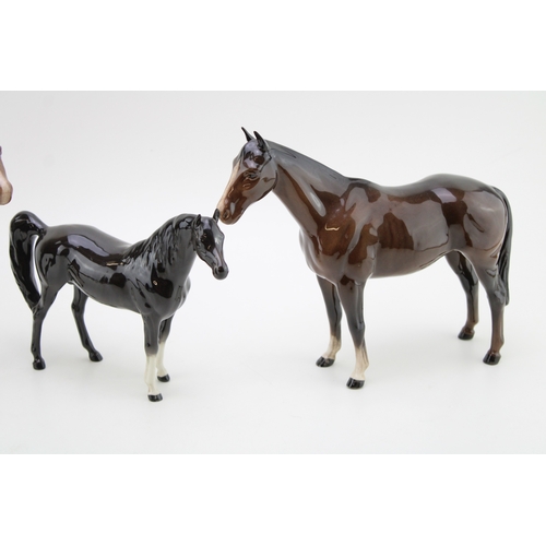 43 - Beswick brown horses to include a brown / charcoal arab xayal, a swishtail and an imperial (3).