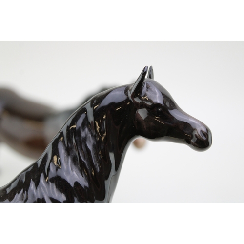 43 - Beswick brown horses to include a brown / charcoal arab xayal, a swishtail and an imperial (3).