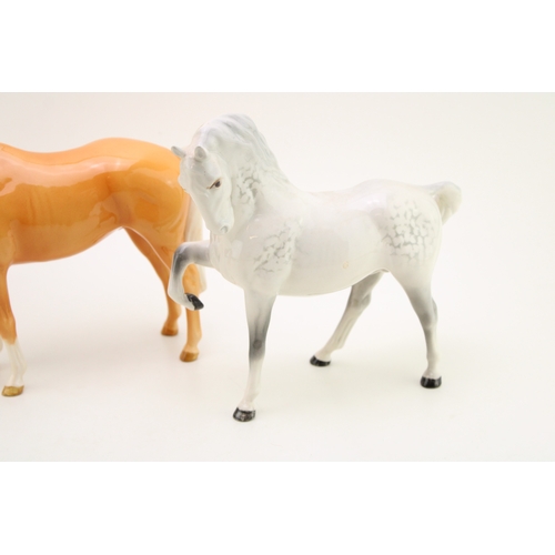 54 - Beswick to include two 1549 leg tucked models in grey and brown with a palomino imperial (3).