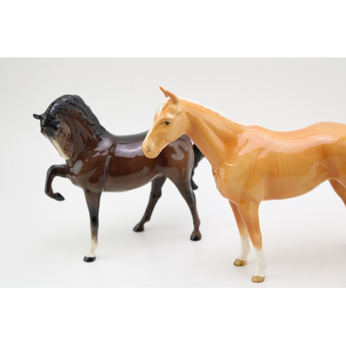 54 - Beswick to include two 1549 leg tucked models in grey and brown with a palomino imperial (3).