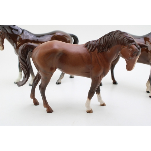 55 - Three Beswick horses to include a quarter horse, a mare facing left and a matt brown Doulton example... 