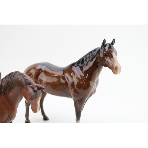 55 - Three Beswick horses to include a quarter horse, a mare facing left and a matt brown Doulton example... 