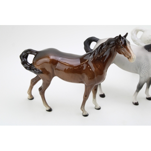 56 - Beswick Swishtail horses to include a grey, a brown and a matt gey example (3).