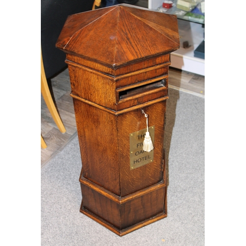 1 - An early 20th century oak country house postbox or letterbox, with later applied brass plaque, hexag... 