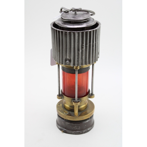 19 - A WWII ere Miners lamp, Patterson of Felling H.C.P, patent two with red glass, 31cm tall.