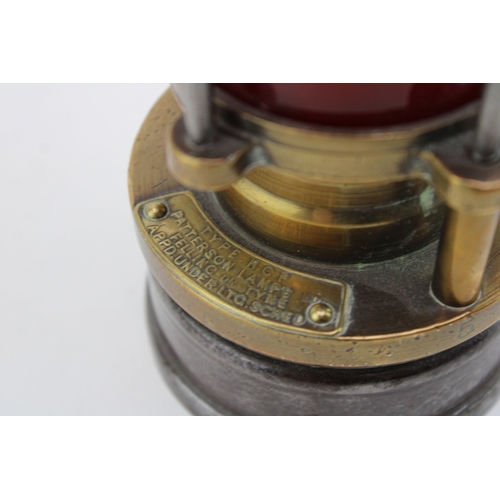 19 - A WWII ere Miners lamp, Patterson of Felling H.C.P, patent two with red glass, 31cm tall.