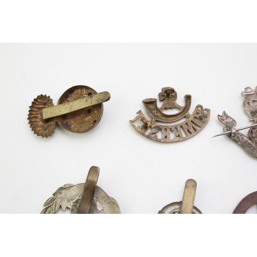 24 - A collection of WW1 & WW2 British Army cap badges including Bedfordshire, Notts & Derby, Hampshire, ... 
