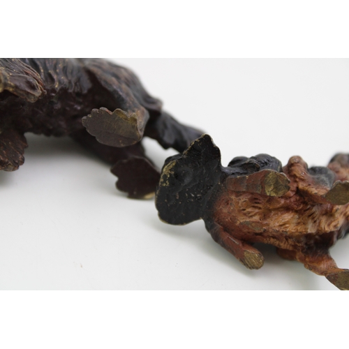 4 - A cold painted bronze figure of a Cavelier King Charles Spaniel, in standing pose, 5.5cm high, appar... 